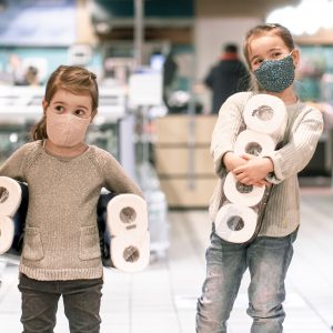 Children shopping at the supermarket during the pandemic .